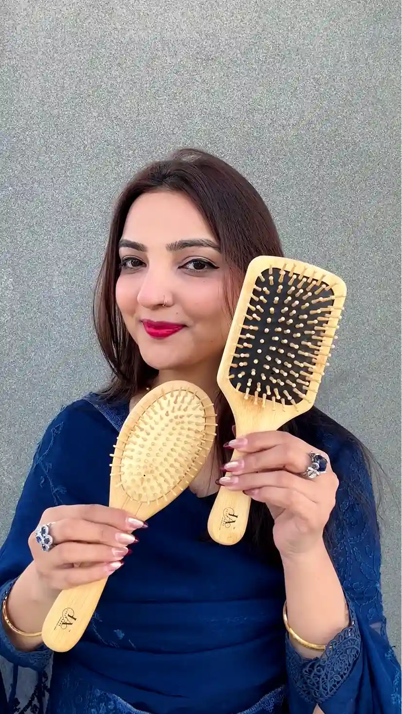 Just Amna two wooden hairbrushes held together, oval and paddle styles, engraved logos