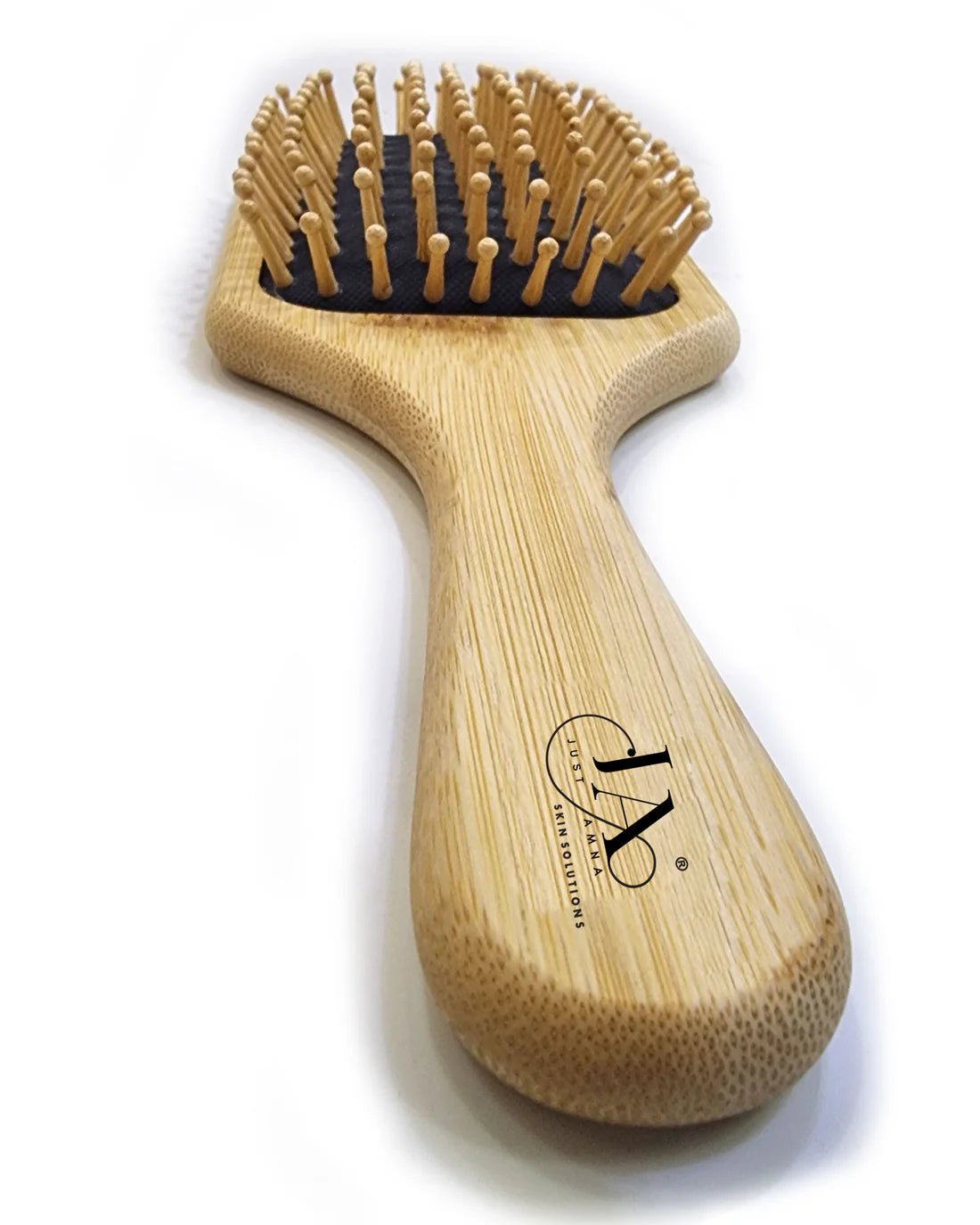 Just Amna bamboo paddle brush with natural wood finish and bristles